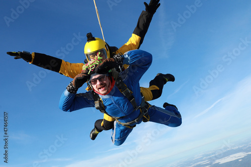 Skydiving. Tandem jump. Two men are flying in the sky.