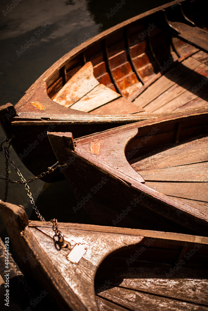 Fototapeta premium Three wooden boats on a lake