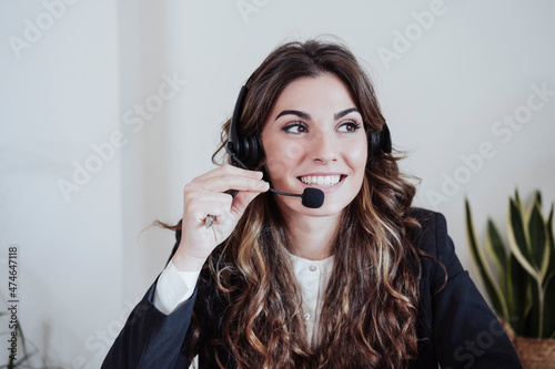 Customer service representative talking on headset at office