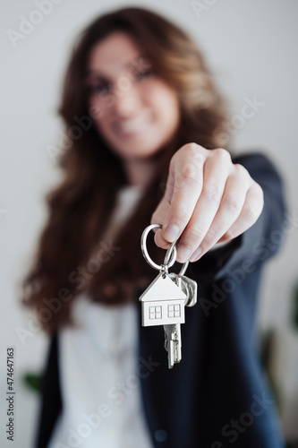 Real estate agent holding house keys at office
