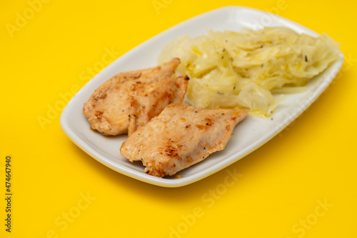 grilled chicken breast with boiled cabbage on the dish