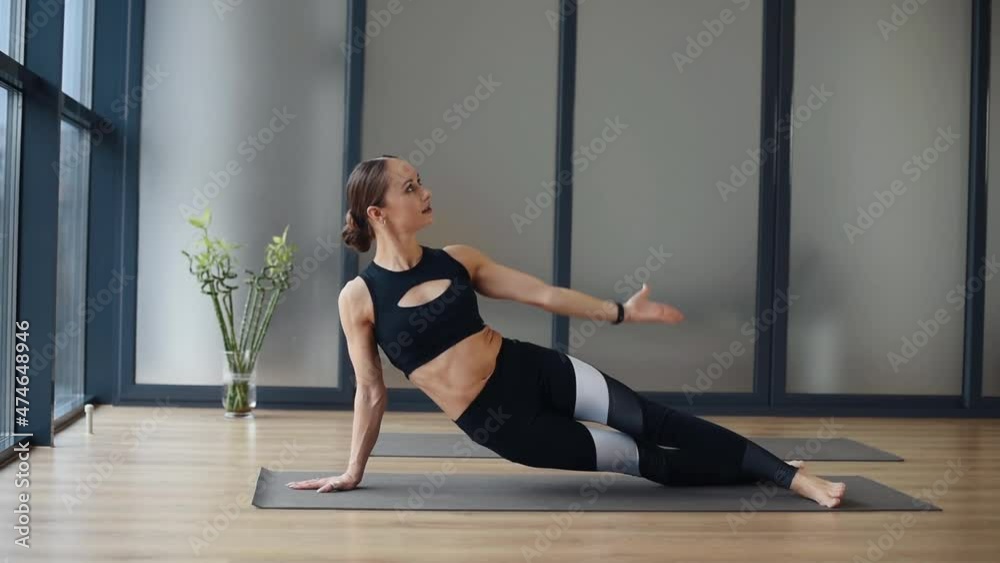Yoga stretch for the spine. Young sportive woman doing fitness exercises indoors Yoga stretch for the spine. Young sportive woman doing fitness exercises indoors