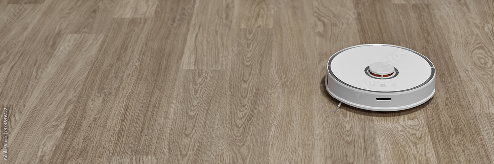 Banner with a robot vacuum cleaner. The robot vacuum cleaner cleans the room. Banner with a robot vacuum cleaner. The robot vacuum cleaner cleans the room.