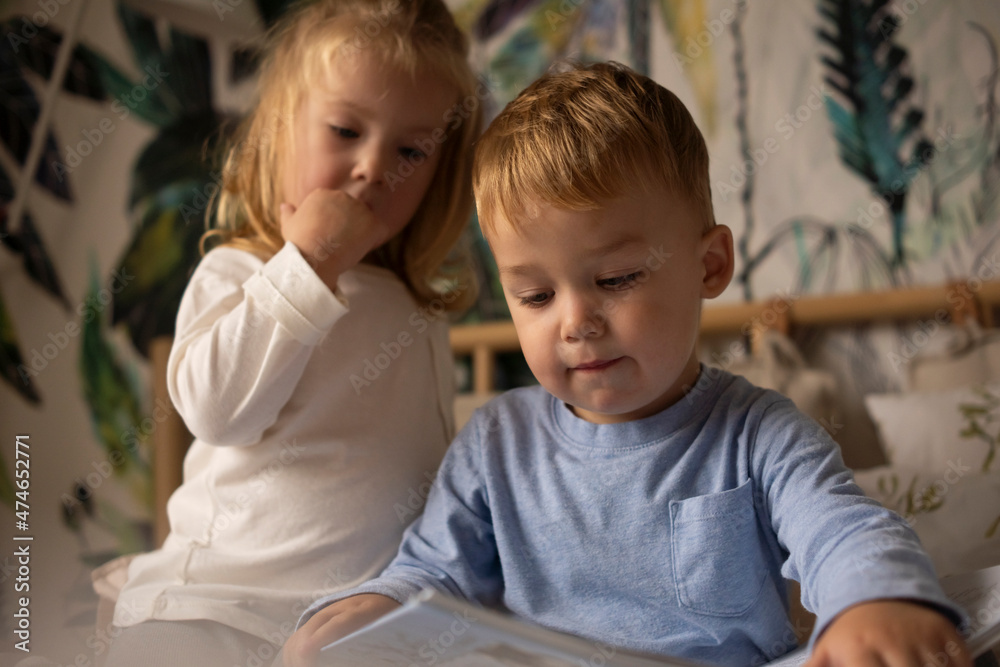 Twins reading book at home Twins reading book at home