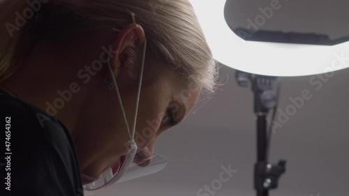 Permanent makeup specialist to paint the eyebrows of the client