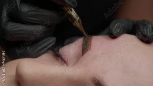 Close-up of permanent makeup on the eyebrows
