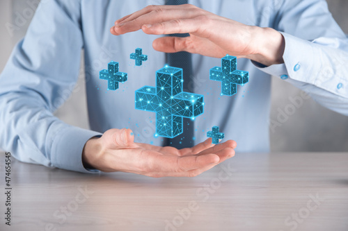 Businessman hand holding 3D plus low polygonal icon.Plus sign virtual means to offer positive thing like benefits, personal development, social network Profit,health insurance, growth concepts.