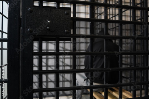 Fotografie The grating of the temporary detention cell in which the detainee is sitting
