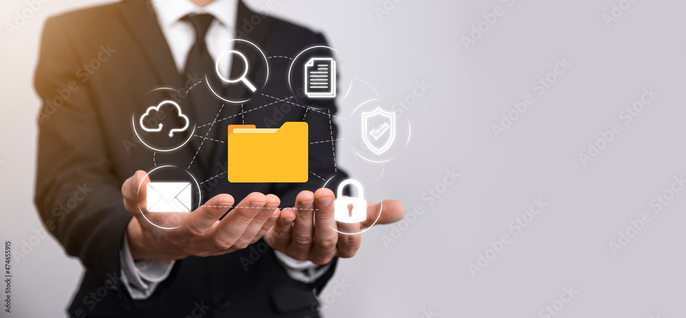 Document Management System DMS .Businessman hold folder and document icon.Software for archiving, searching and managing corporate files and information.Internet Technology Concept.Digital security