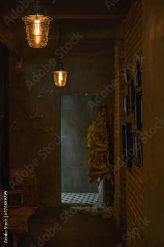 Dark hall in the coffee shop with antique lamps. Pictures on the wall. Cafe interior. High quality photo