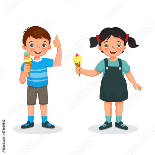 Cute little boy and girl holding and eating ice cream showing thumb up and smiling facial expression