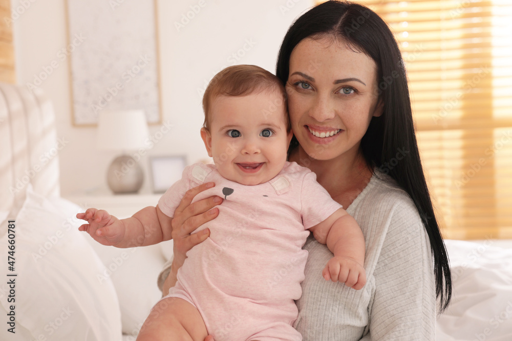 Happy woman with her little baby on bed at home Happy woman with her little baby on bed at home