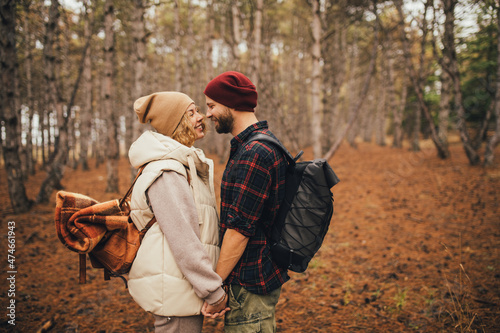Couple in love hiking together in a forest. Millennial hipsters travelers spending time together.