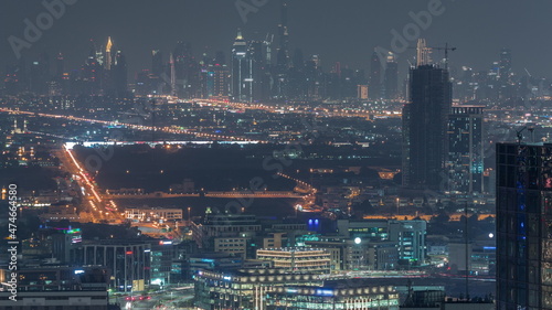 Dubai Downtown skyline row of skyscrapers with tallset tower aerial night timelapse. UAE