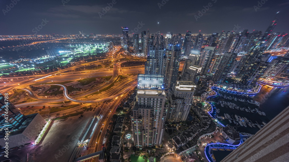 Fototapeta premium Dubai marina and JLT skyscrapers along Sheikh Zayed Road aerial night timelapse.