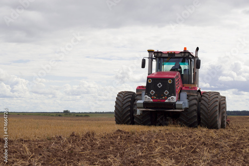 modern tractor in field cultivating soil