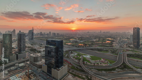 Sunrise over highway junction near media city and al barsha heights district area timelapse from Dubai marina.