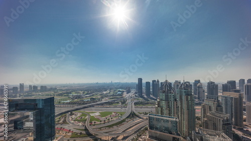 Dubai marina and JLT skyscrapers along Sheikh Zayed Road aerial all day timelapse.