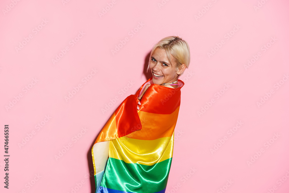 White woman laughing while posing with rainbow flag White woman laughing while posing with rainbow flag