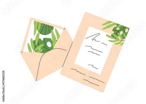 Open envelope and postcard. Greeting post card with handwritten message. Shee...