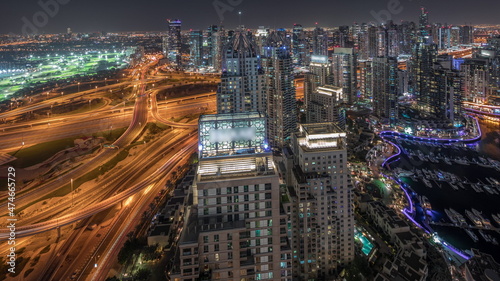 Panorama showing Dubai marina and JLT skyscrapers along Sheikh Zayed Road aerial night timelapse. © neiezhmakov