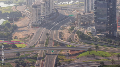 Huge highway crossroad junction between JLT district and Dubai Marina intersected by Sheikh Zayed Road aerial all day timelapse.