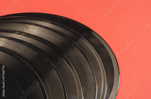 Old vinyl records on a red background. A group of gramophone rec photo
