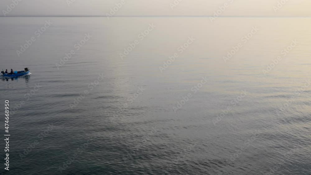 Beautiful sunrise over the sea with fishermen boat. Slow motion 4K Beautiful sunrise over the sea with fishermen boat. Slow motion 4K