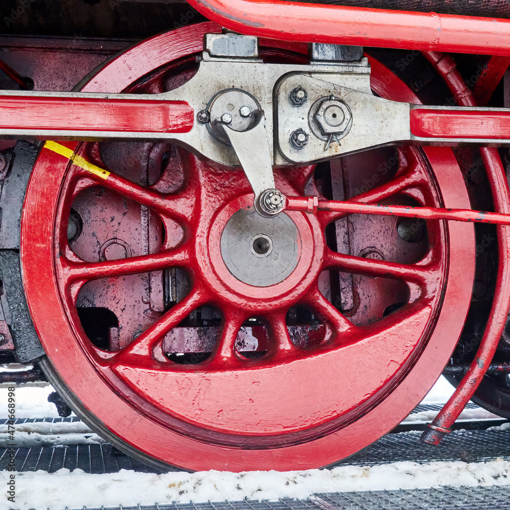 Fototapeta premium Detail of red iron drive wheel of old steam locomotive