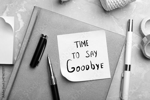 Note with text Tome to say Goodbye and stationery on table, flat lay. Black and white tone