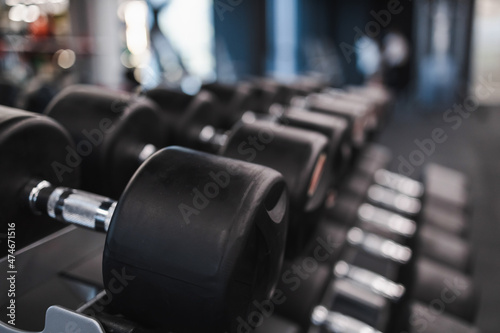 Rows of dumbbells on rack in gym