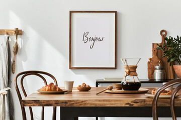 Stylish composition of cozy dining room intrerior with mock up poster frame, wooden family dining table, plants and vintage personal accessories. Copy space. Template. Autumn vibes.