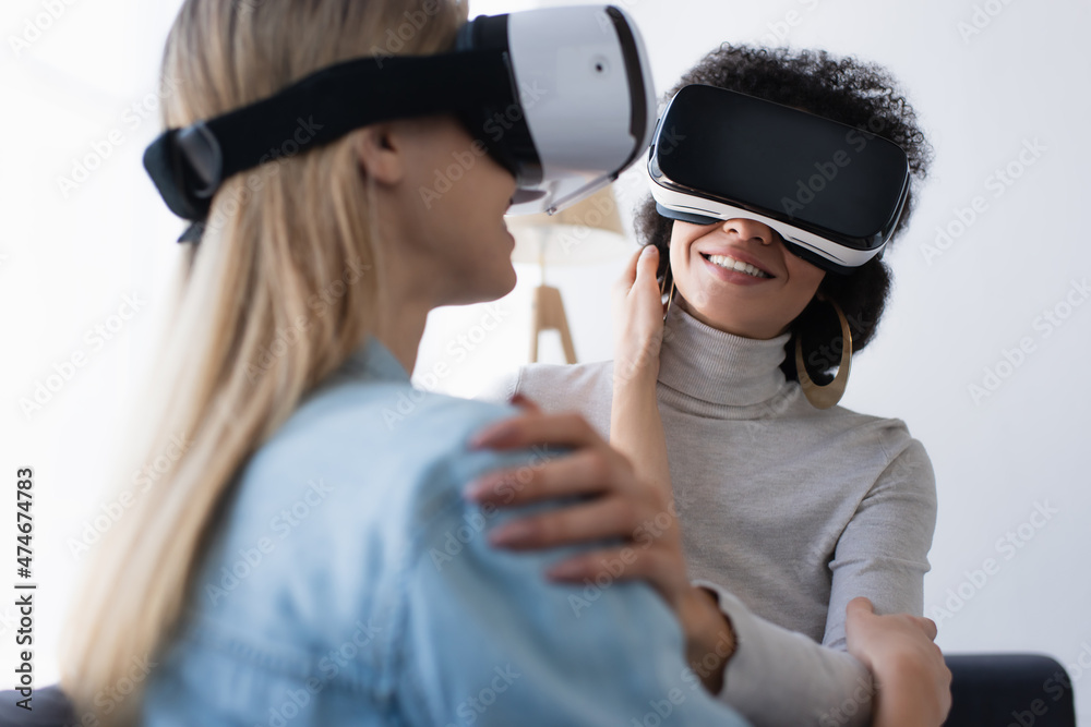 Diskant Crack pot coping smiling african american women and her blurred lesbian girlfriend gaming in  vr headsets at home Stock-Foto | Adobe Stock
