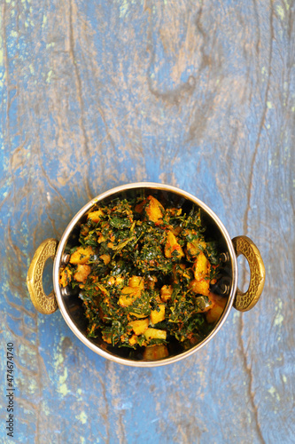 Indian Cuisine Aloo Methi Sabji or Fenugreek potato sabji. served in a karahi.