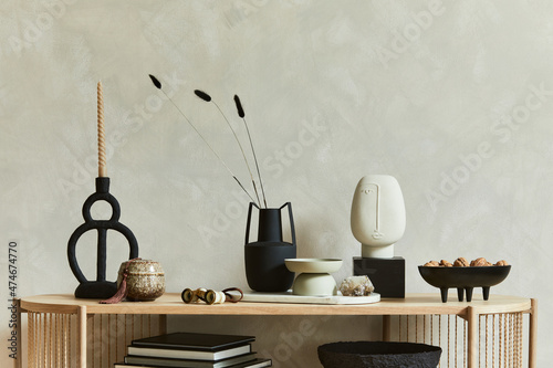 Stylish composition of personal accessories on the console in the living room. Sculpture, candlectick, minerals and tray. Copy space. Template. photo