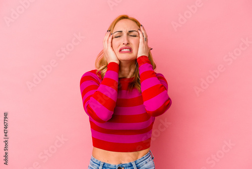 Young caucasian woman isolated on pink background whining and crying disconsolately.