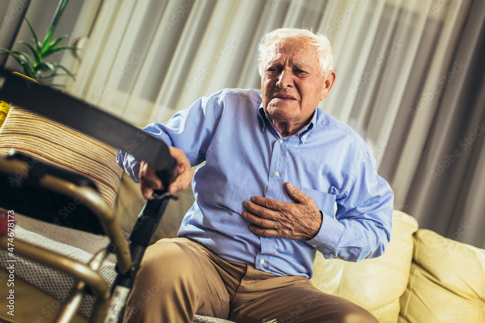 Senior man with chest pain suffering from heart attack at home Senior man with chest pain suffering from heart attack at home