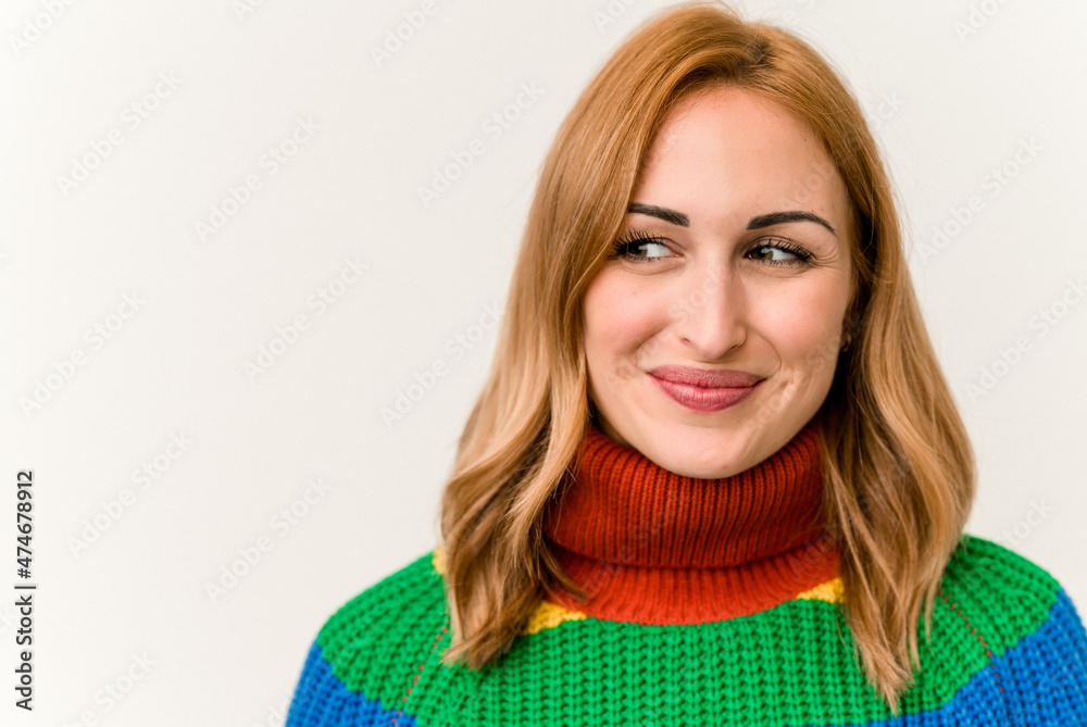 Young caucasian woman wearing a sweater with stripes isolated on white background Young caucasian woman wearing a sweater with stripes isolated on white background