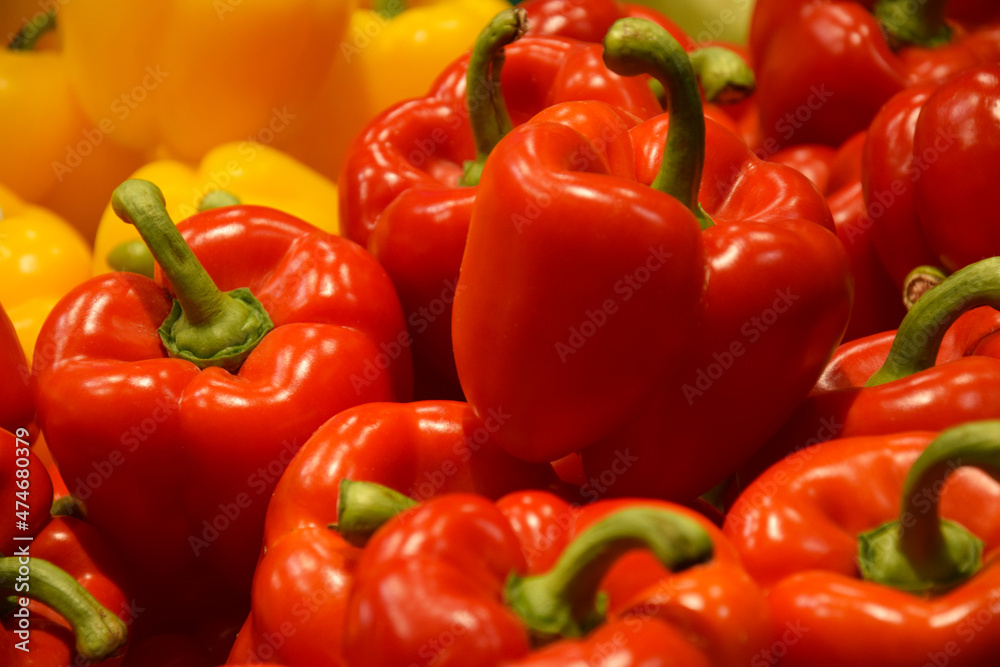 Fresh red and yellow organic bell peppers on the counter in the supermarket. Fresh red and yellow organic bell peppers on the counter in the supermarket.