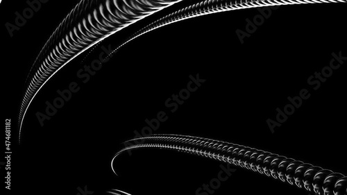 Twisted metal silver tube on a black background. Design. Metal tangle is unraveling and disappearing.