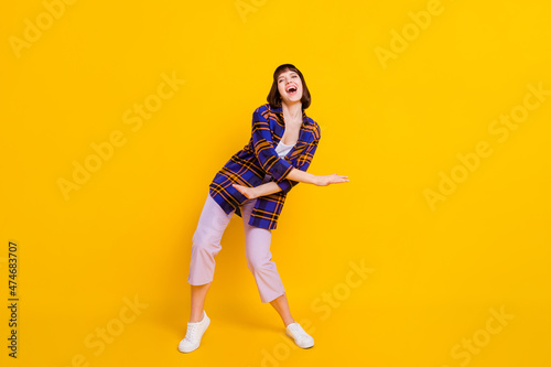 Full length body size view of attractive cheerful girl dancing having fun chill out isolated over bright yellow color background