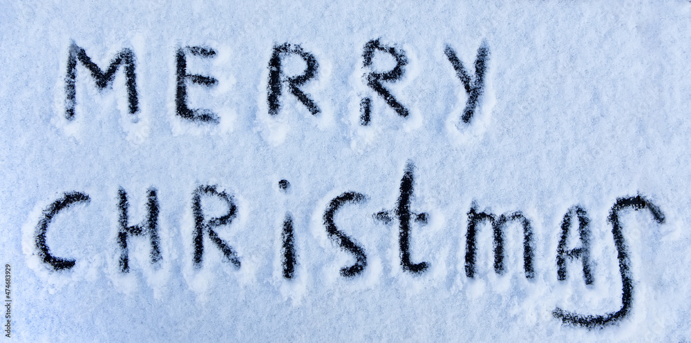 Merry Christmas words written on snow field. Merry Christmas words written on snow field.