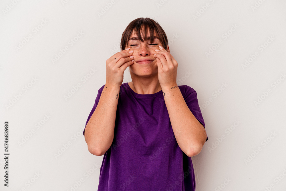 Young Argentinian woman isolated on white background doubting between two options.