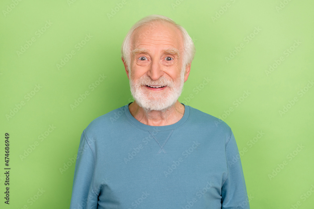 Photo of optimistic aged beard man wear blue sweater isolated on green color background Photo of optimistic aged beard man wear blue sweater isolated on green color background