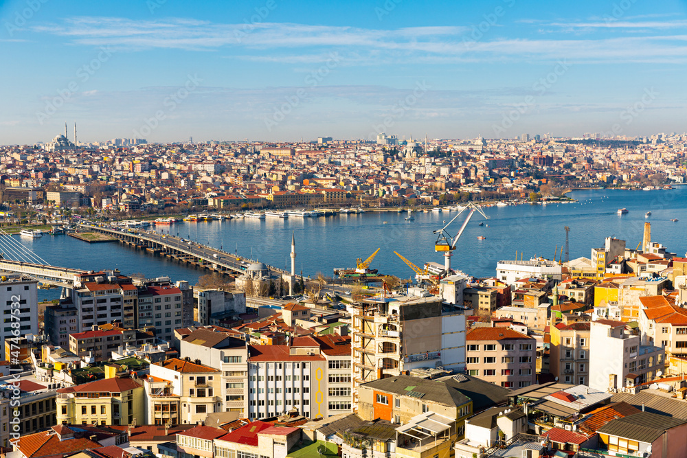 Scenic view from Galata Tower of Golden Horn bay with Ataturk Bridge in Istanbul on sunny winter day, Turkey