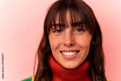 Young Argentinian woman isolated on pink background