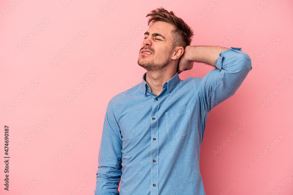 Young caucasian man isolated on pink background tired and very sleepy keeping hand on head. Young caucasian man isolated on pink background tired and very sleepy keeping hand on head.