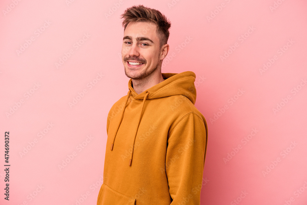 Young caucasian man isolated on pink background confident keeping hands on hips. Young caucasian man isolated on pink background confident keeping hands on hips.