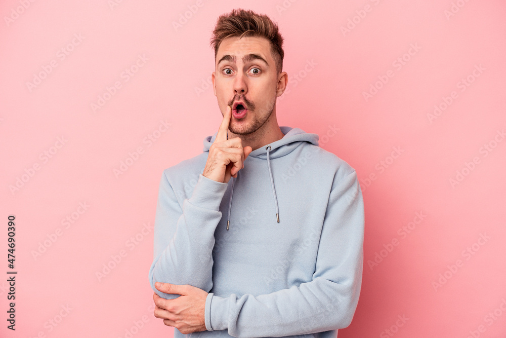 Young caucasian man isolated on pink background having some great idea, concept of creativity.