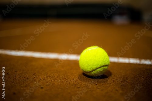 Tennis ball on the tennis court. Gravel. Tennis game. Sport, recreation concept © Dmitry